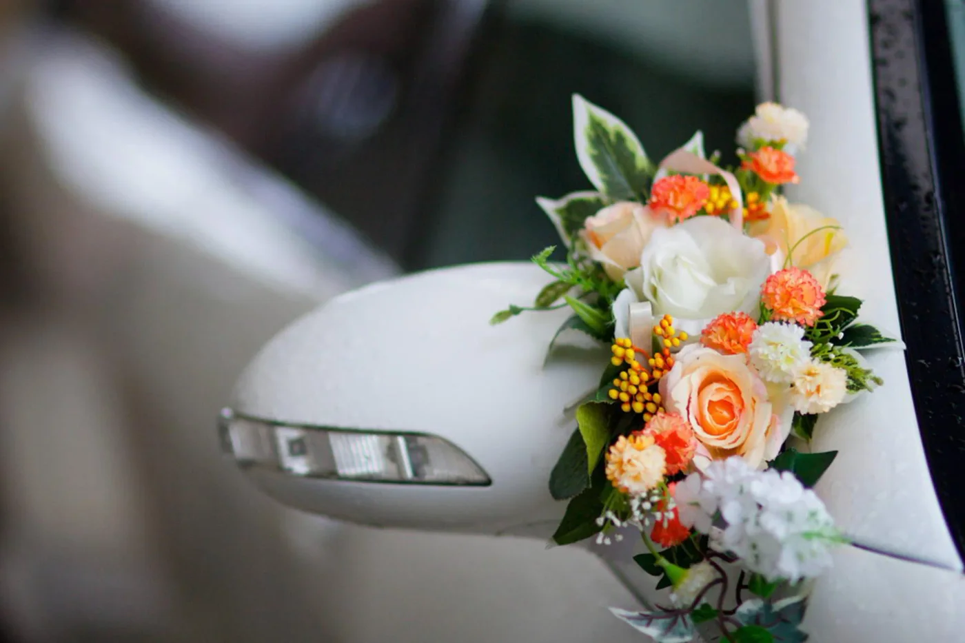 White wing mirror decorated with peach and ivory flowers