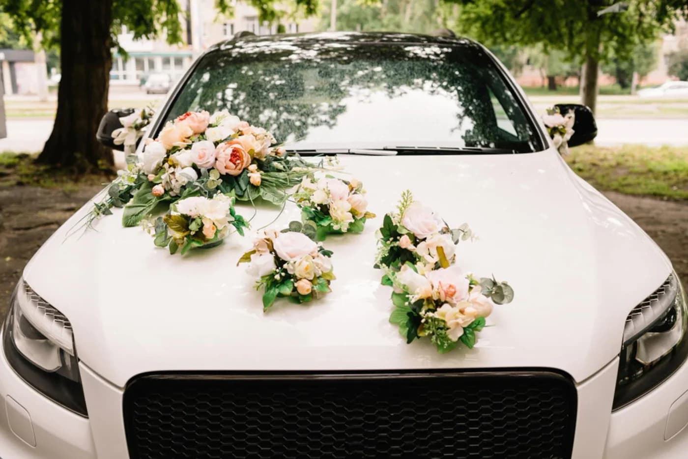 White Jaguar with a pink and white floral bonnet arrangement