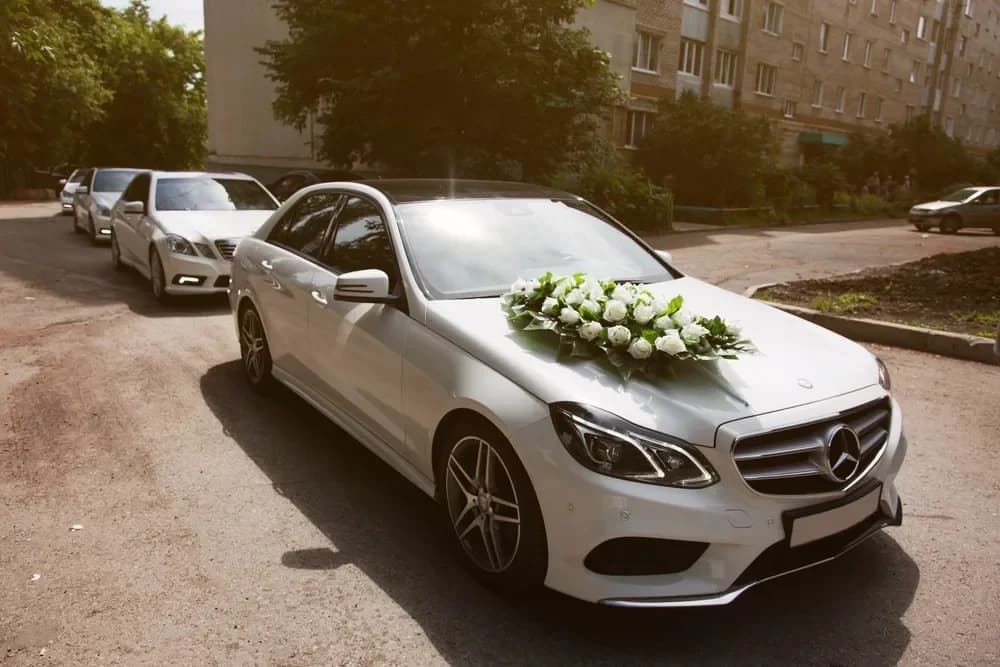 Silver Mercedes convertible with a floral bonnet arrangement