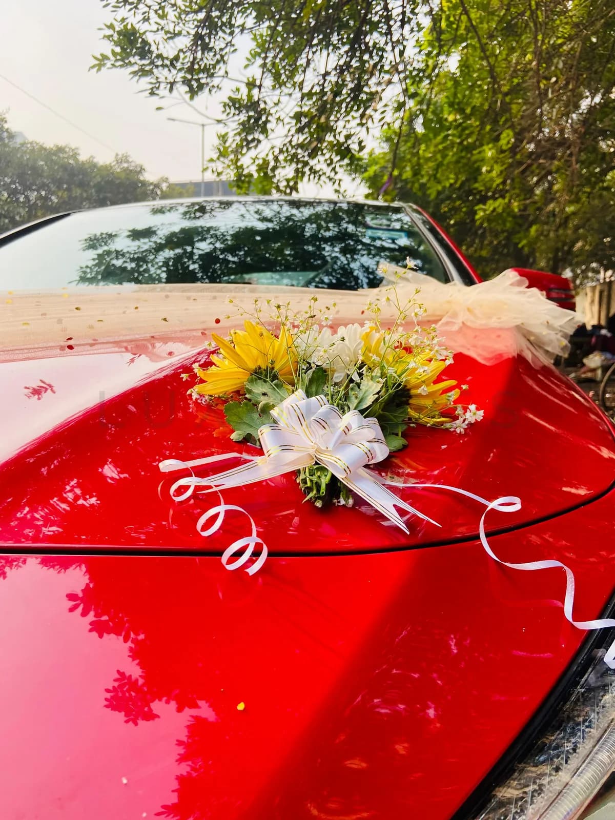 Red Mercedes-Benz CLA bonnet decorated with flowers and ivory fabric