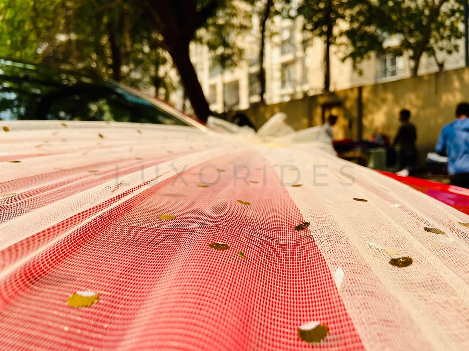Ivory fabric and gold accents across a red Mercedes-Benz CLA bonnet