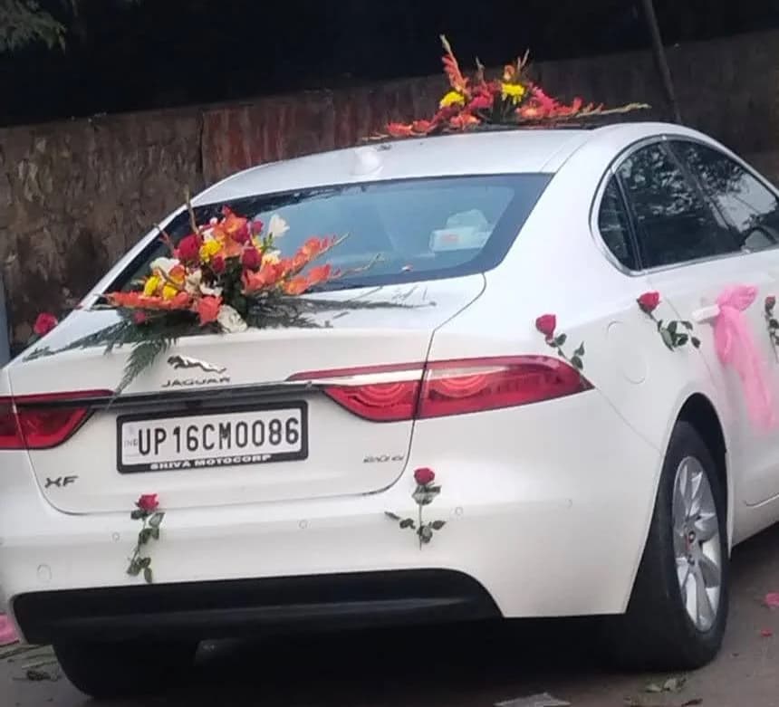 Rear of a white Jaguar XF decorated with roses and colourful flowers