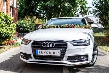 White Audi convertible with flowers across the bonnet