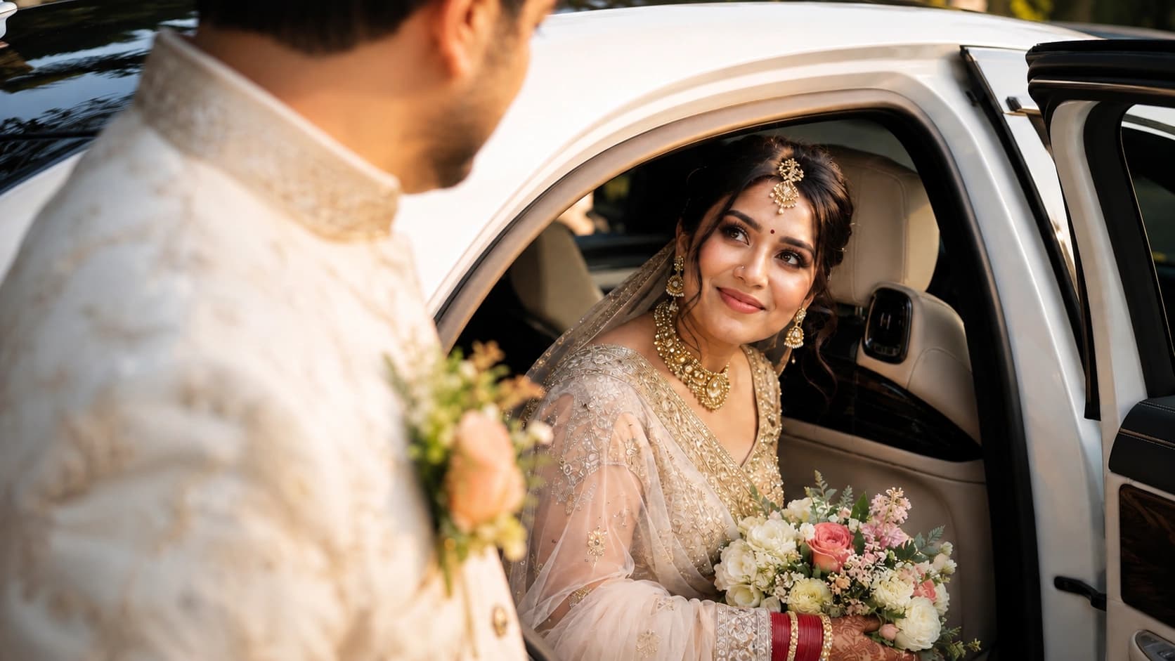 Indian bride seated in a white wedding car looking toward the groom
